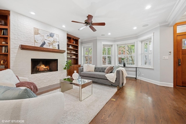 3715 N Wayne Ave, Chicago, IL 60613 - living room featuring crown molding, built in features, a stone fireplace, recessed lighting, and dark wood-style floors