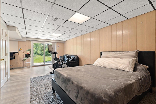 10401 Lismore Ct, Orland Park, IL 60462 - bedroom featuring light wood-style floors, a drop ceiling, wooden walls, and access to exterior