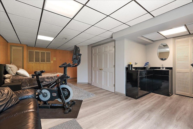 10401 Lismore Ct, Orland Park, IL 60462 - workout area featuring wood walls, light wood finished floors, and a drop ceiling