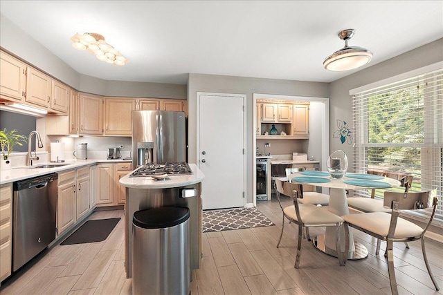 10401 Lismore Ct, Orland Park, IL 60462 - kitchen featuring stainless steel appliances, light countertops, wood finish floors, a kitchen island, and light brown cabinets