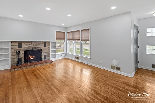 902 W Downer Pl, Aurora, IL 60506 - unfurnished living room featuring hardwood / wood-style floors, a fireplace, and recessed lighting