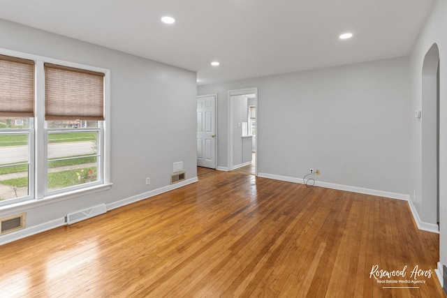 902 W Downer Pl, Aurora, IL 60506 - empty room featuring arched walkways, hardwood / wood-style flooring, and recessed lighting