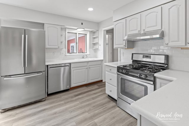 902 W Downer Pl, Aurora, IL 60506 - kitchen with appliances with stainless steel finishes, under cabinet range hood, white cabinetry, and recessed lighting
