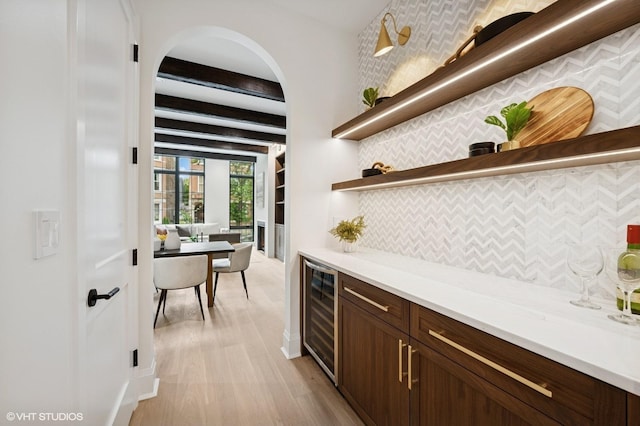 838 N Damen Ave Unit 1, Chicago, IL 60622 - indoor dry bar with wine cooler, tasteful backsplash, light wood finished floors, and beamed ceiling