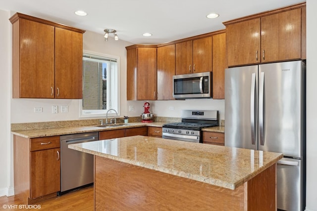 6123 S Kimbark Ave Unit 2N, Chicago, IL 60637 - kitchen featuring appliances with stainless steel finishes, light stone countertops, recessed lighting, brown cabinetry, and light wood-type flooring