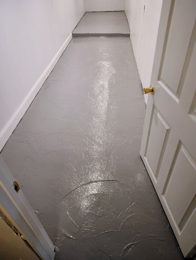 detailed view of baseboards and finished concrete floors