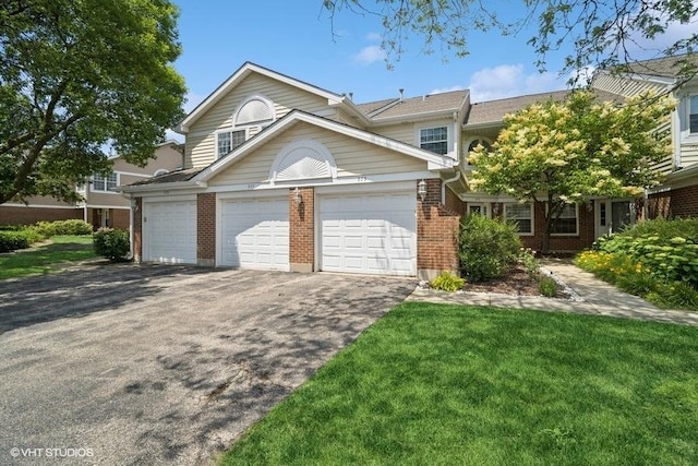 975 W Happfield Dr, Arlington Heights, IL 60004 - multi unit property featuring brick siding, driveway, an attached garage, and a front yard