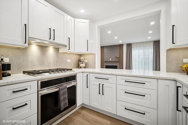 975 W Happfield Dr, Arlington Heights, IL 60004 - kitchen with stainless steel appliances, light stone countertops, light wood-type flooring, backsplash, and recessed lighting