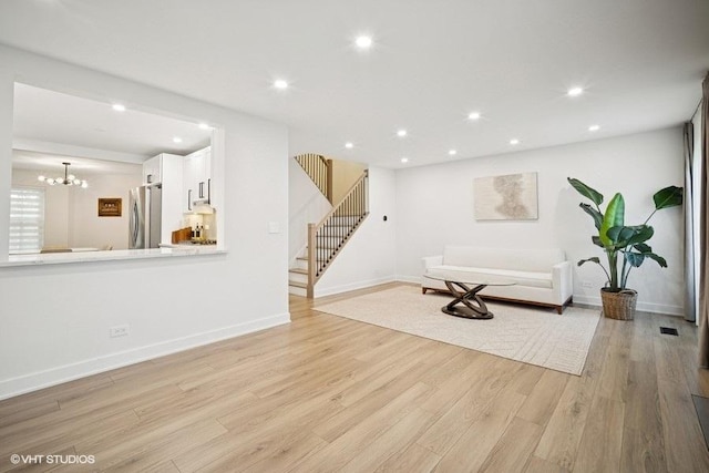 975 W Happfield Dr, Arlington Heights, IL 60004 - living room featuring light wood-type flooring, stairs, recessed lighting, and a chandelier
