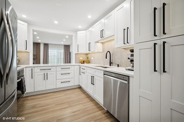975 W Happfield Dr, Arlington Heights, IL 60004 - kitchen with stainless steel appliances, light countertops, white cabinetry, backsplash, and recessed lighting