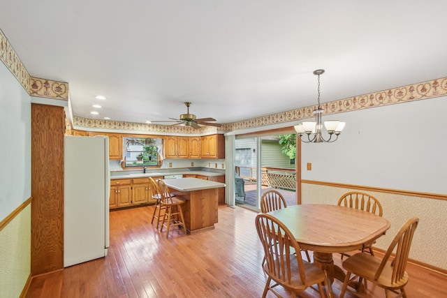 3560 Primrose Ln, Morris, IL 60450 - dining area featuring light wood-style floors, a ceiling fan, and a chandelier