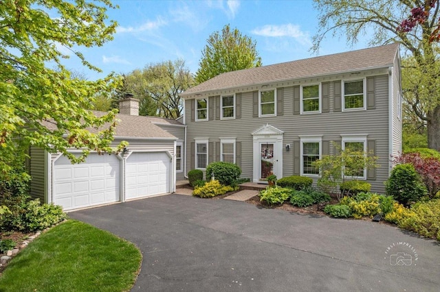 1228 N W St, Naperville, IL 60563 - colonial home with an attached garage, driveway, and a chimney