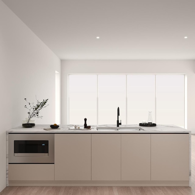 2147 W Adams St Unit 3N, Chicago, IL 60612 - kitchen with light wood finished floors, built in microwave, modern cabinets, light stone countertops, and recessed lighting