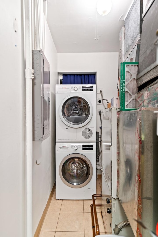 431 S Dearborn St Unit 1303, Chicago, IL 60605 - washroom featuring stacked washing machine and dryer and light tile patterned floors