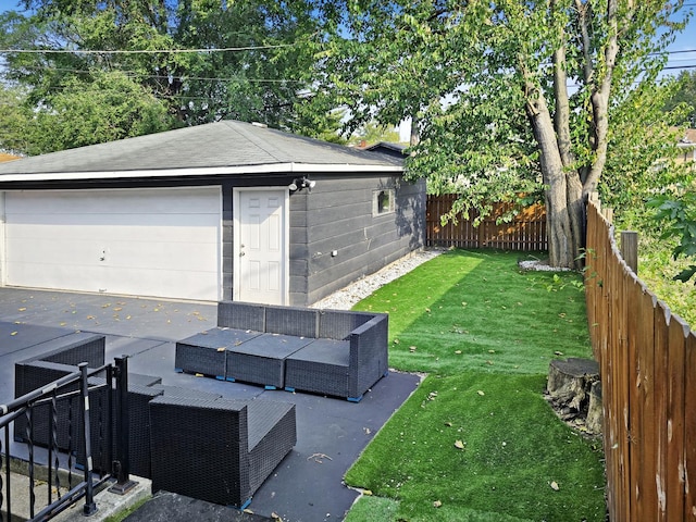 301 Cornell Ave, Calumet City, IL 60409 - fenced backyard with an outdoor hangout area, a detached garage, an outbuilding, and a patio