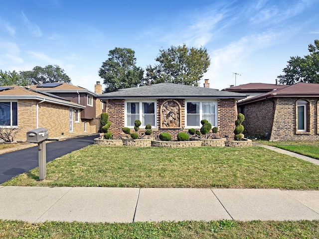 301 Cornell Ave, Calumet City, IL 60409 - view of front of home with brick siding, a chimney, and a front yard
