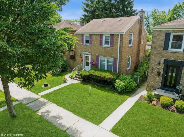 3837 Kirk St, Skokie, IL 60076 - view of front of property with a chimney, a front yard, and brick siding