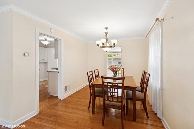 3837 Kirk St, Skokie, IL 60076 - dining room featuring light wood finished floors, a chandelier, and crown molding