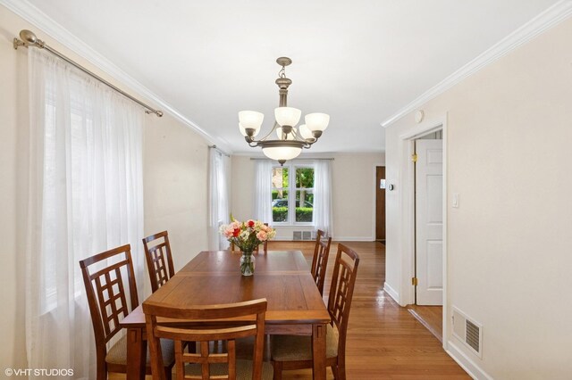 3837 Kirk St, Skokie, IL 60076 - dining space with a chandelier, light wood-style flooring, and crown molding