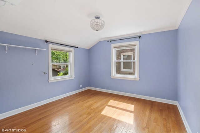 3837 Kirk St, Skokie, IL 60076 - empty room with wood finished floors and vaulted ceiling