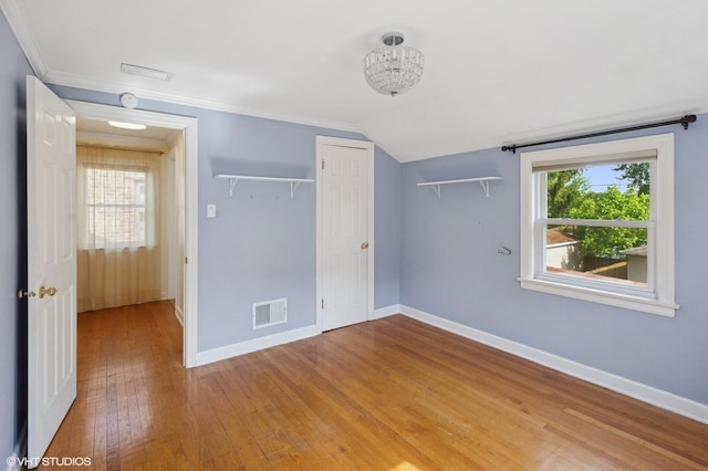 3837 Kirk St, Skokie, IL 60076 - unfurnished bedroom with hardwood / wood-style floors, a closet, lofted ceiling, and crown molding