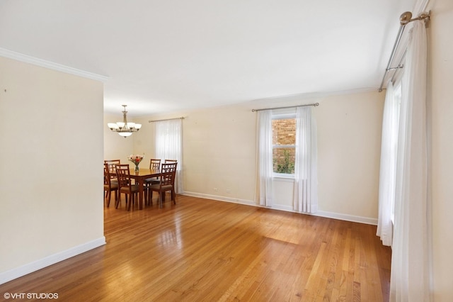 3837 Kirk St, Skokie, IL 60076 - dining room featuring crown molding, light wood-type flooring, and a chandelier