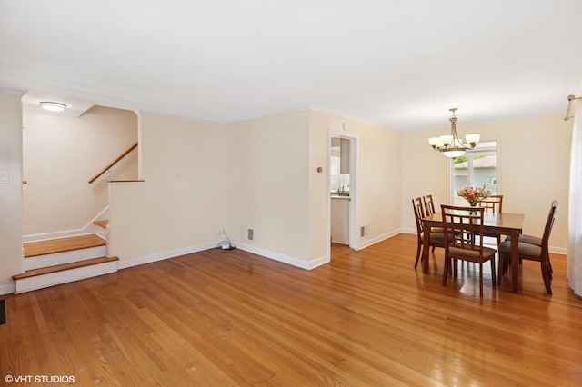 3837 Kirk St, Skokie, IL 60076 - dining area featuring a chandelier, light wood finished floors, stairs, and crown molding