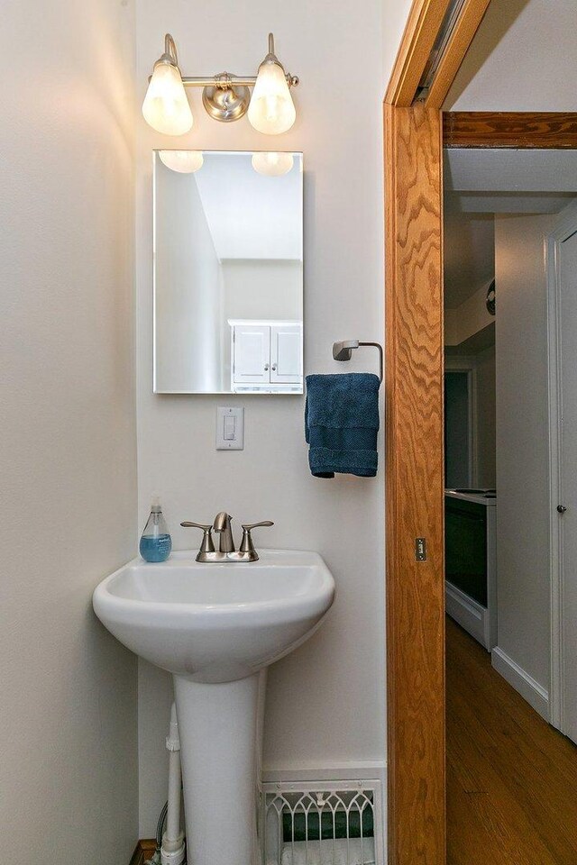 218 Mason Ct, Sycamore, IL 60178 - bathroom featuring wood finished floors and a sink
