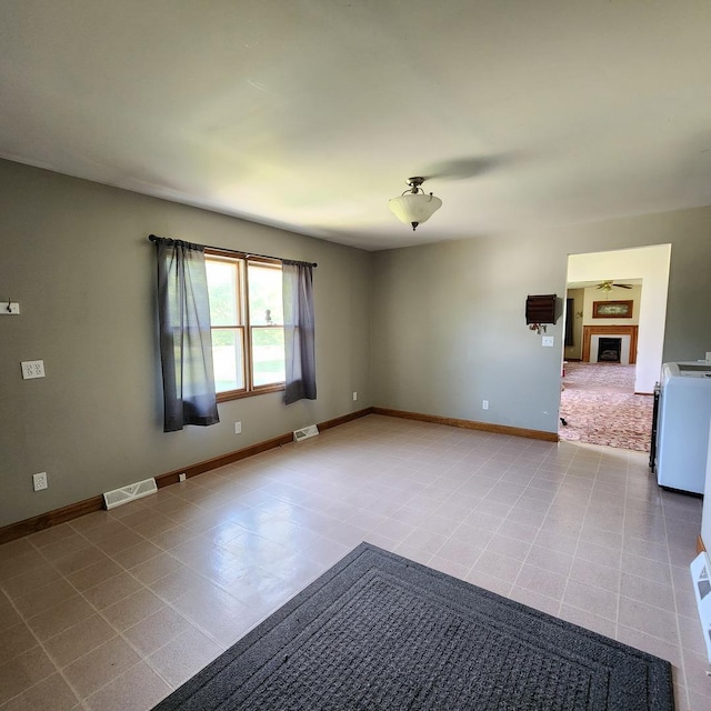 1932 N 2653rd Rd, Ottawa, IL 61350 - spare room with a fireplace and washer / clothes dryer