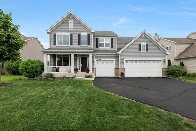 9054 Clinnin Ln, Huntley, IL 60142 - traditional-style home featuring a porch, driveway, a front lawn, and an attached garage