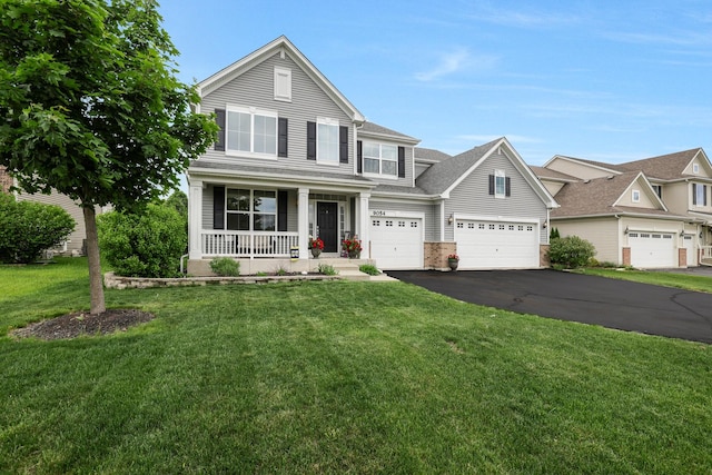 9054 Clinnin Ln, Huntley, IL 60142 - view of front of property with covered porch, driveway, a front lawn, and brick siding
