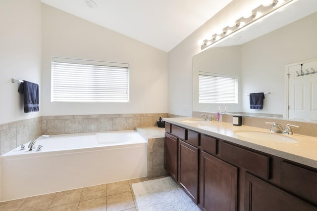9054 Clinnin Ln, Huntley, IL 60142 - bathroom featuring double vanity, vaulted ceiling, tile patterned flooring, and a garden tub
