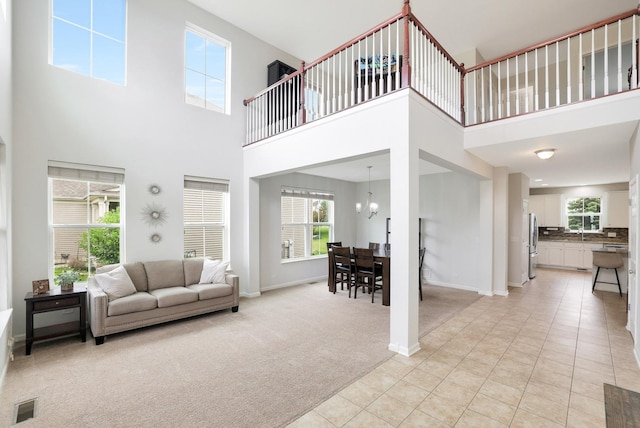 9054 Clinnin Ln, Huntley, IL 60142 - living area featuring a towering ceiling, light carpet, healthy amount of natural light, and light tile patterned flooring