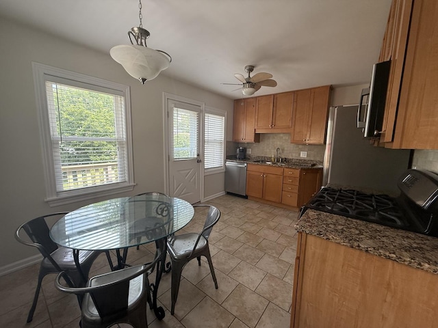 1757 Linden St, Des Plaines, IL 60018 - kitchen featuring stainless steel appliances, decorative backsplash, ceiling fan, hanging light fixtures, and brown cabinetry