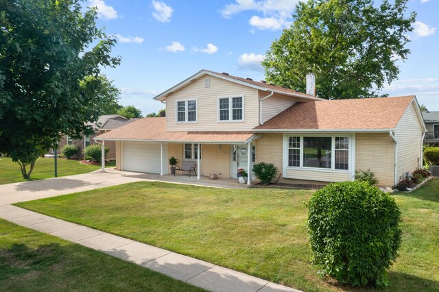 1558 Oregon Trl, Elk Grove Village, IL 60007 - traditional home with concrete driveway, an attached garage, a front yard, and brick siding