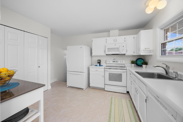 1558 Oregon Trl, Elk Grove Village, IL 60007 - kitchen with white appliances, white cabinets, light tile patterned floors, and light countertops