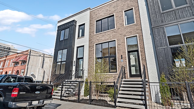 336 E Pershing Rd, Chicago, IL 60653 - view of building exterior with a fenced front yard and entry steps