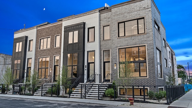 336 E Pershing Rd, Chicago, IL 60653 - townhome / multi-family property featuring a fenced front yard and brick siding