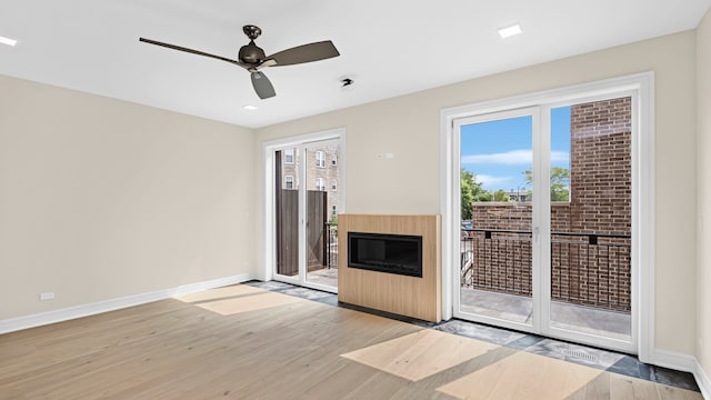 336 E Pershing Rd, Chicago, IL 60653 - unfurnished living room featuring light wood-style floors, a glass covered fireplace, a ceiling fan, and recessed lighting