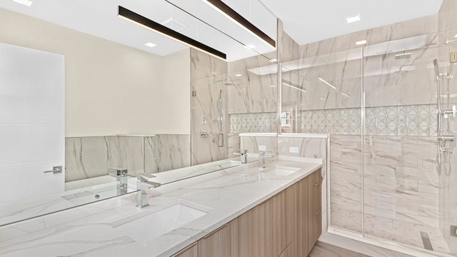336 E Pershing Rd, Chicago, IL 60653 - full bathroom featuring a marble finish shower, double vanity, and tile walls