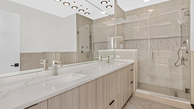 336 E Pershing Rd, Chicago, IL 60653 - bathroom with double vanity, a stall shower, tile walls, and marble finish flooring