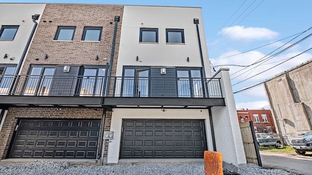 336 E Pershing Rd, Chicago, IL 60653 - rear view of house featuring brick siding, a balcony, and an attached garage
