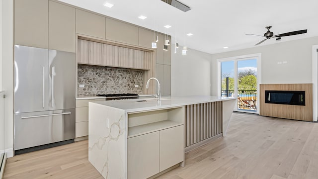 336 E Pershing Rd, Chicago, IL 60653 - kitchen with high end fridge, modern cabinets, decorative backsplash, light wood-style floors, and a ceiling fan