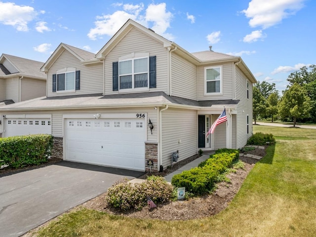 956 Tuscany Trl, Hampshire, IL 60140 - view of front of home with an attached garage, a front lawn, driveway, and stone siding