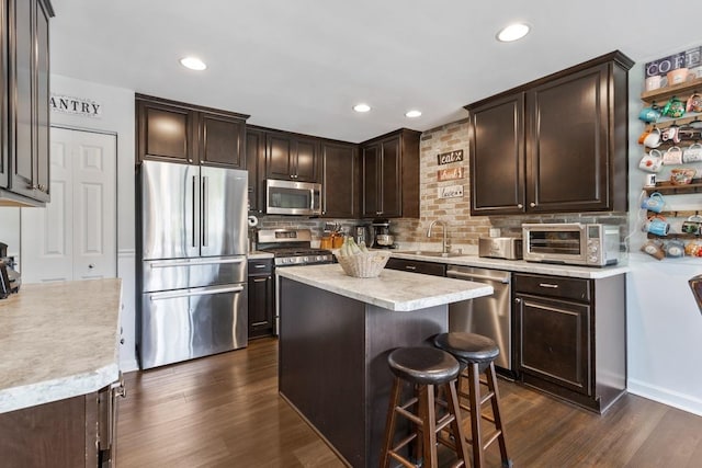 956 Tuscany Trl, Hampshire, IL 60140 - kitchen featuring appliances with stainless steel finishes, dark brown cabinets, tasteful backsplash, light countertops, and dark wood-style flooring