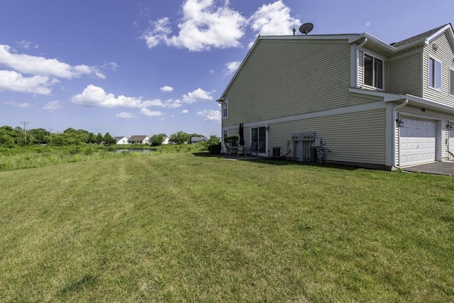 39709 N Warren Ln, Beach Park, IL 60083 - view of side of home with a lawn, a garage, and asphalt driveway