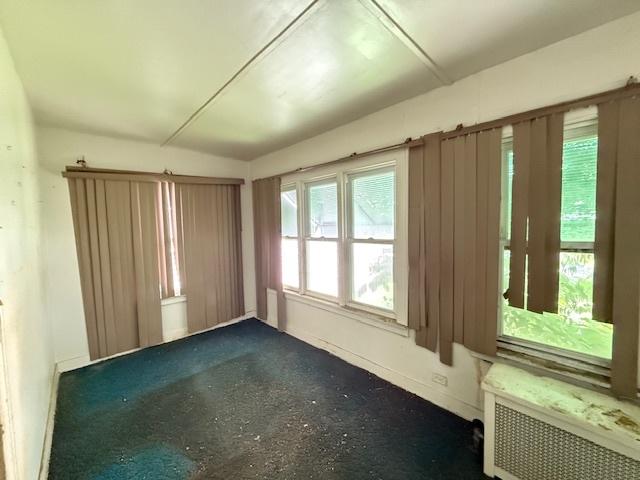 7806 S Avalon Ave, Chicago, IL 60619 - spare room featuring radiator heating unit