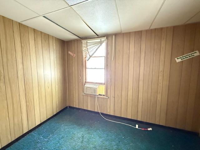 7806 S Avalon Ave, Chicago, IL 60619 - empty room with carpet flooring, wooden walls, and cooling unit