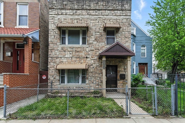 2240 S Avers Ave, Chicago, IL 60623 - view of front of property with stone siding, a gate, and a fenced front yard