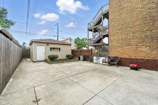 2240 S Avers Ave, Chicago, IL 60623 - fenced backyard featuring a patio, an outbuilding, and stairs
